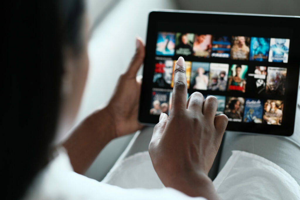 Nearly half (49%) of UK adults discover new brands via streaming TV ads, with the number rising to 74% among adult Gen Z and millennials, a new Amazon Ads report has revealed, here depicting a woman watching streaming TV