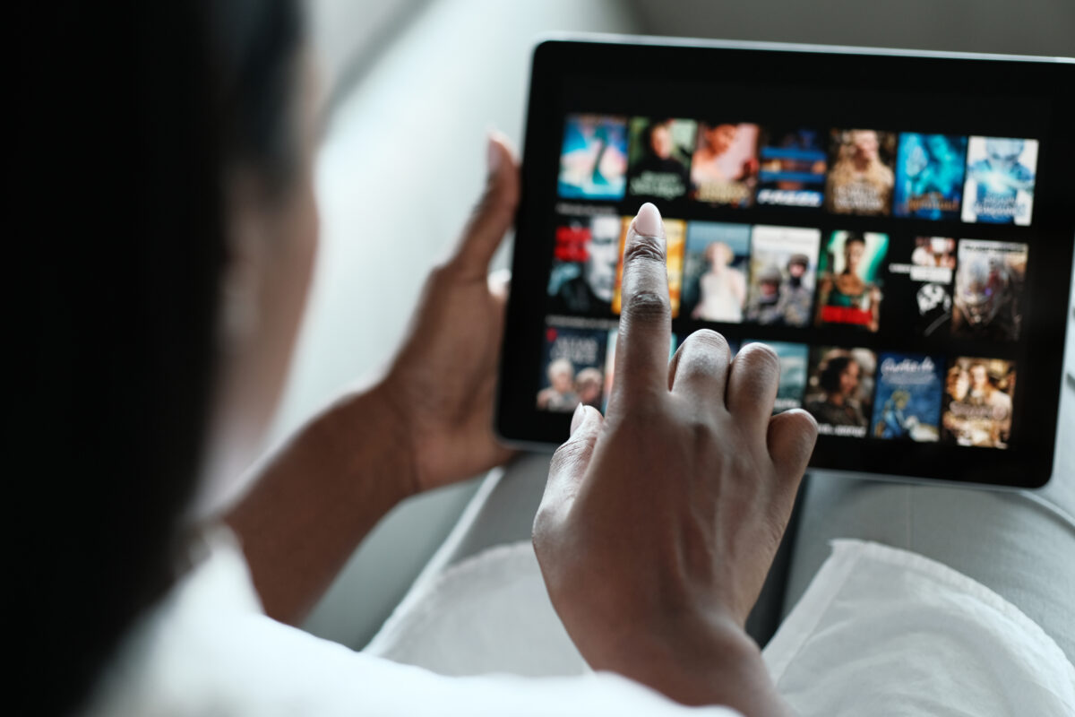 Nearly half (49%) of UK adults discover new brands via streaming TV ads, with the number rising to 74% among adult Gen Z and millennials, a new Amazon Ads report has revealed, here depicting a woman watching streaming TV