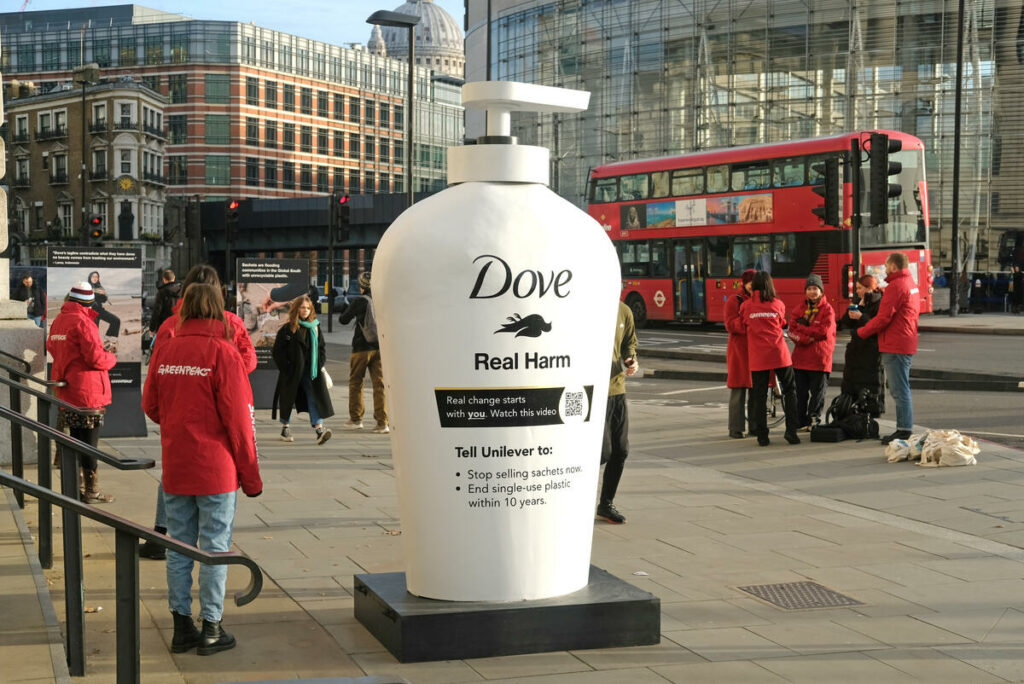 A giant dove buttle with a dead bird and slogan 'Real Harm'. Greenpeace has planted a subversive redesign of the iconic Dove branding outside Unilever’s headquarters, slamming the company for its shocking use of single use plastic.