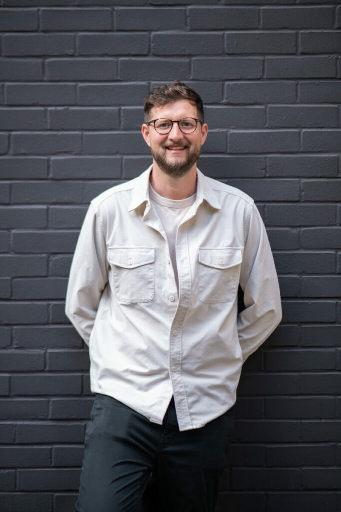 Image of Joe Bruce in front of black brick wall. Above + Beyond has snapped up Wieden + Kennedy creative director Joe Bruce to act as its new executive creative director.
