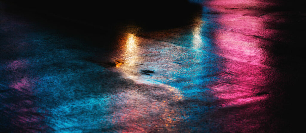 Abstract depiction of lights on the concrete floor of an urban area at night time. Out-of-home infrastructure firm Clear Channel highlights the negative effects of street violence in a new partnership with nationwide LGBT charity Strut Safe