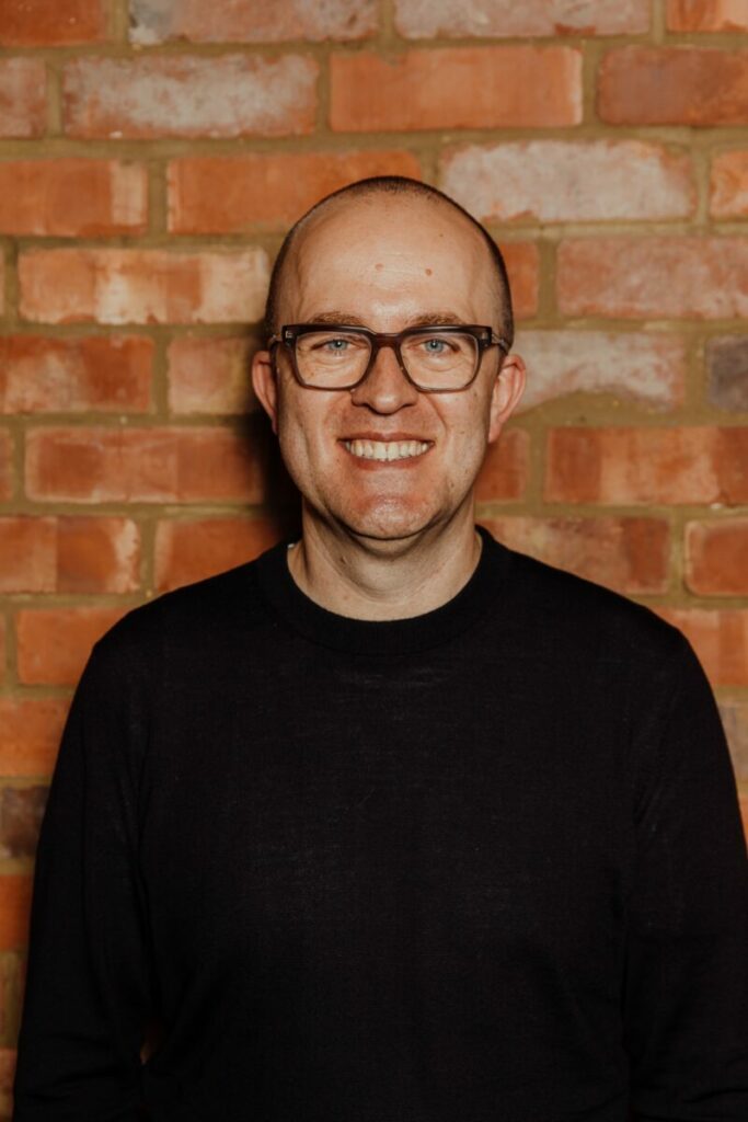 David Murdin stands against a brick wall, smiling and with glasses on. Warner Hotels has snapped up David Murdin, who has leadership experience across British Airways, Sky Sports, Whitbread, Costa Coffee and Wagamama