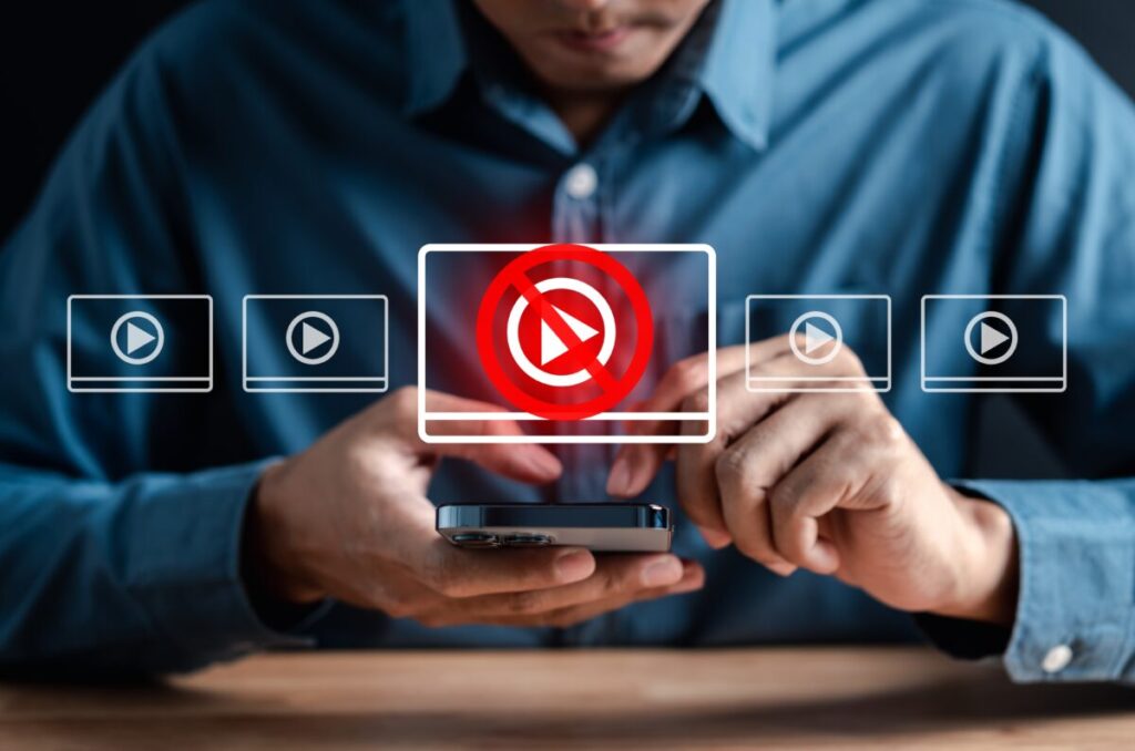 A man attempts to search for something on his phone but is blocked. News publishers may have missed out on crucial Olympics-related advertising revenue because of outdated keyword blocklists.