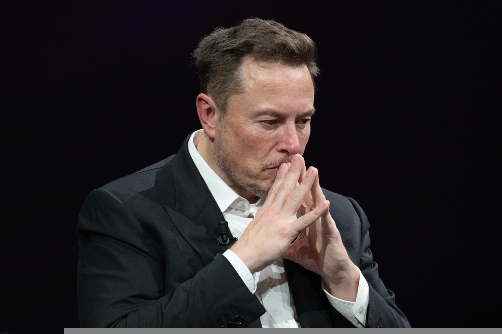 Musk with his hands clasped together. Elon Musk is suing advertisers and major brands over a "massive advertiser boycott", accusing them of conspiring to make X lose money. Marketing Beat asks what the situationw ill mean for advertisers and how they can react.